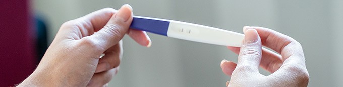 Woman holds a pregnancy test
