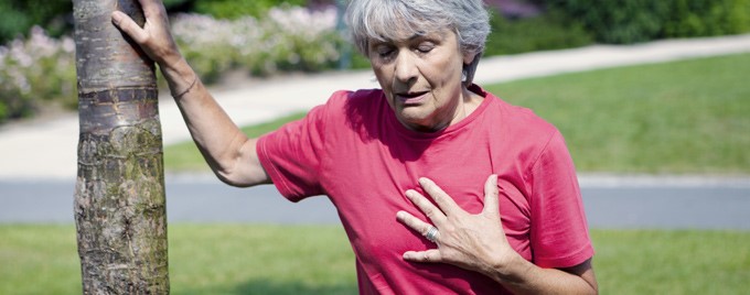 Woman with chest pain holds chest