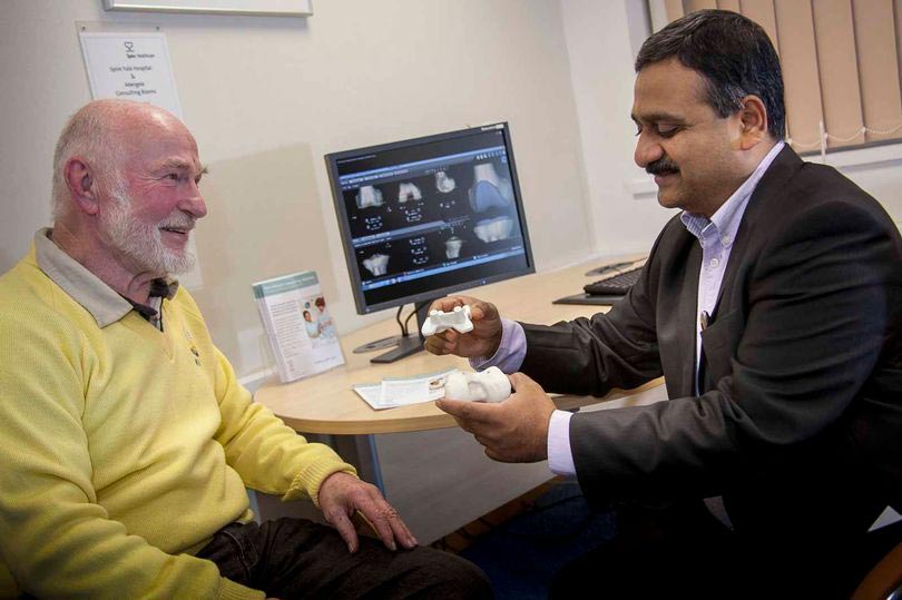 Sugeon Muthu Ganapathi in consultation with patient Mr David Grove after his successful knee replacement operation.jpg