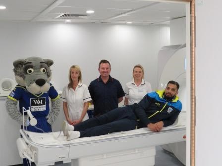 Warrington Wolves star Ryan Atkins and club mascot Wolfie