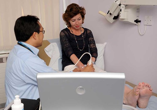Dr Antoni Chan examining a Rheumatoid Arthritis patient