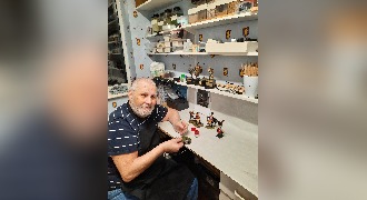 Derek soldiers on painting miniatures after cataract operation