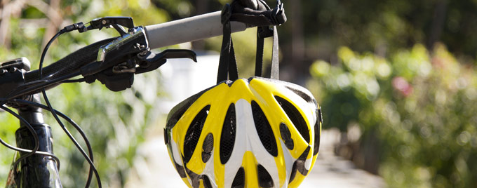 Cycling helmet hanging on some handlebars