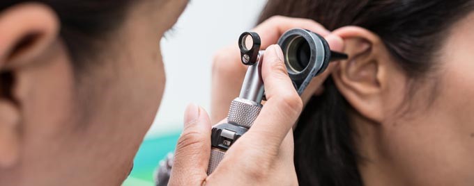 A person receiving an ear examination