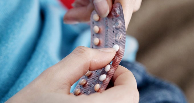 A person holding a packet containing the contraceptive pill