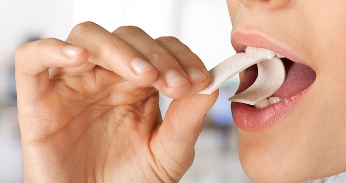 A person chewing a stick of gum