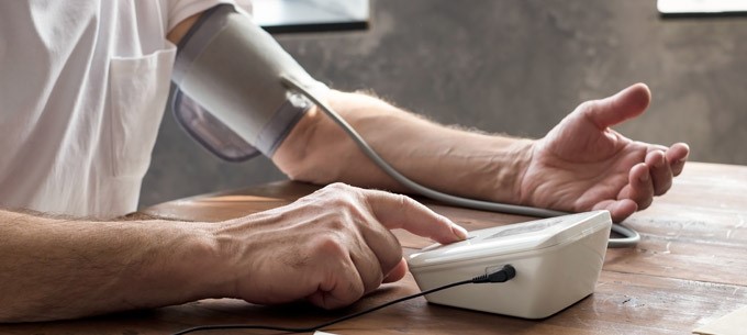 A person checks their blood pressure