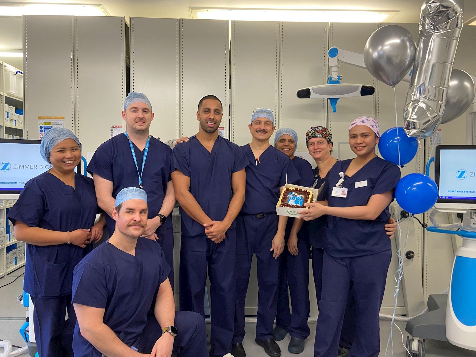 Theatre team celebrating the first ROSA partial knee replacement