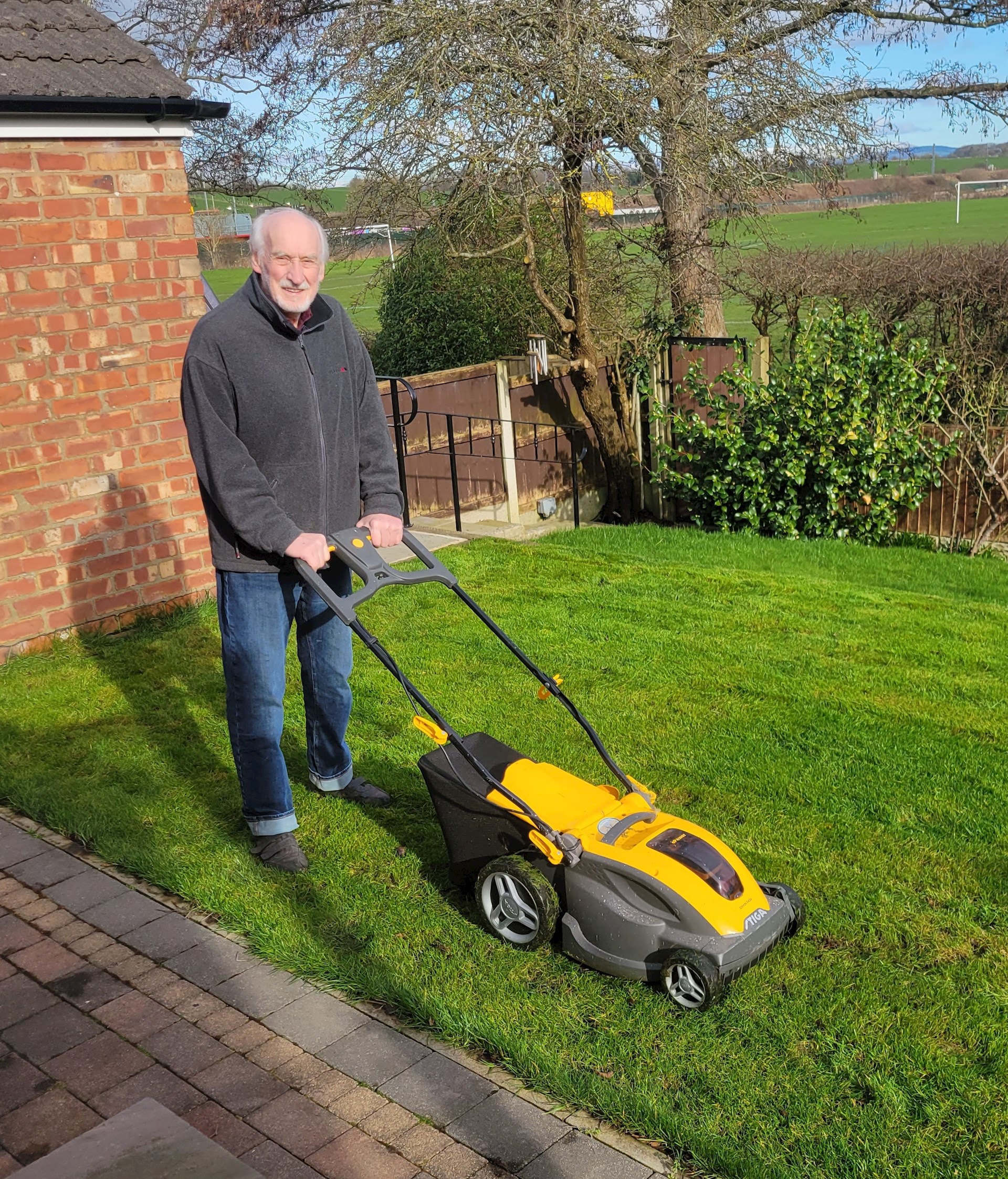Mr Max Read mowing his lawn after Mako robotic-assisted knee replacement at Spire Fylde Coast Hospital